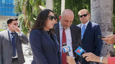 Press conference with officials and journalists outside tropical urban setting
