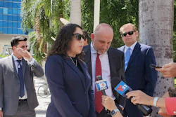 Press conference with officials and journalists outside tropical urban setting