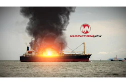 Cargo ship on fire with thick black smoke, Manufacturing Now logo visible