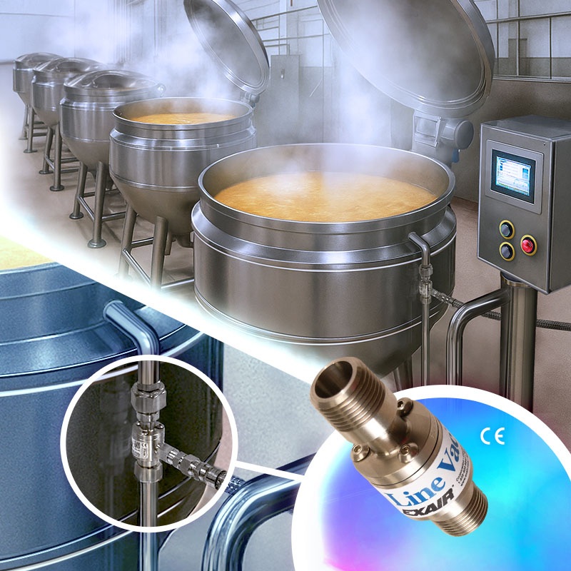 Industrial kitchen with large stainless steel cooking vessels and steam