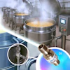Industrial kitchen with large stainless steel cooking vessels and steam
