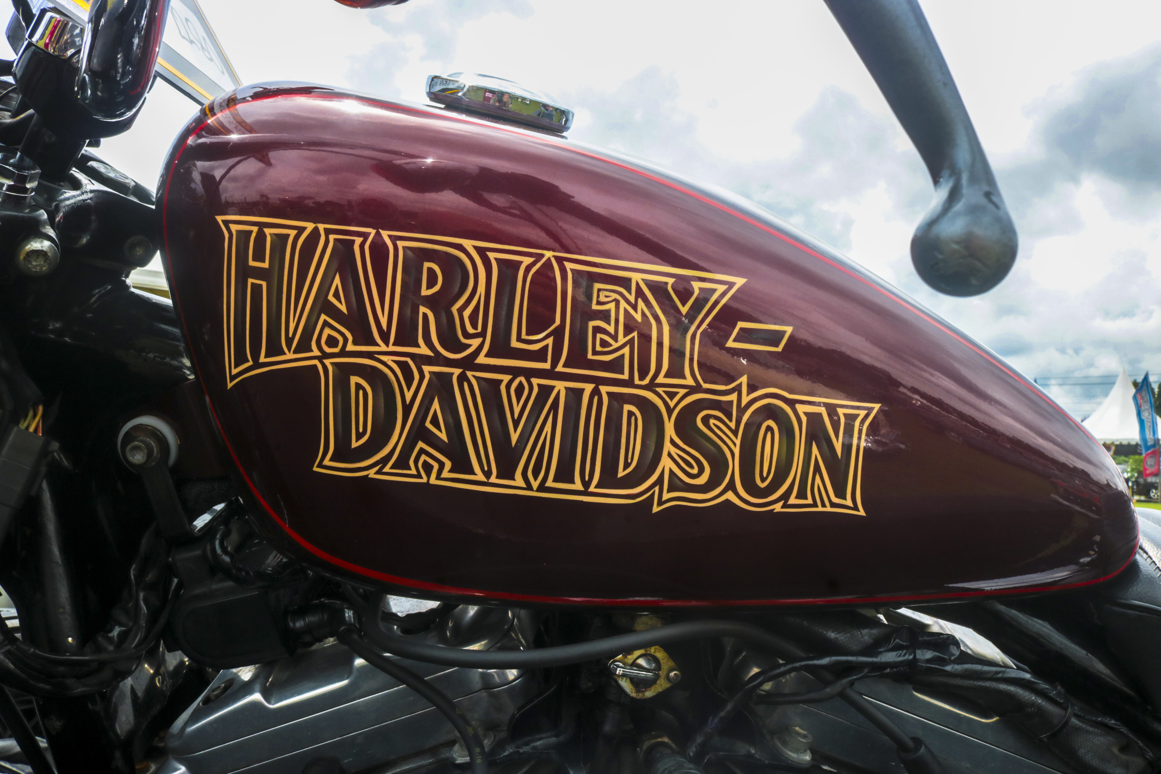 Burgundy Harley-Davidson motorcycle fuel tank with gold lettering