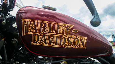 Burgundy Harley-Davidson motorcycle fuel tank with gold lettering