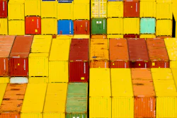 Stacked shipping containers in vibrant yellow, red, and orange colors