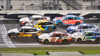 NASCAR race cars competing on track at Daytona International Speedway
