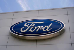 Ford automotive logo in blue and white on modern building exterior