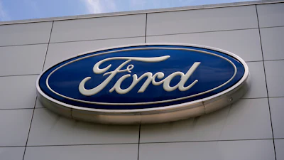 Ford automotive brand logo in blue and white on modern building exterior