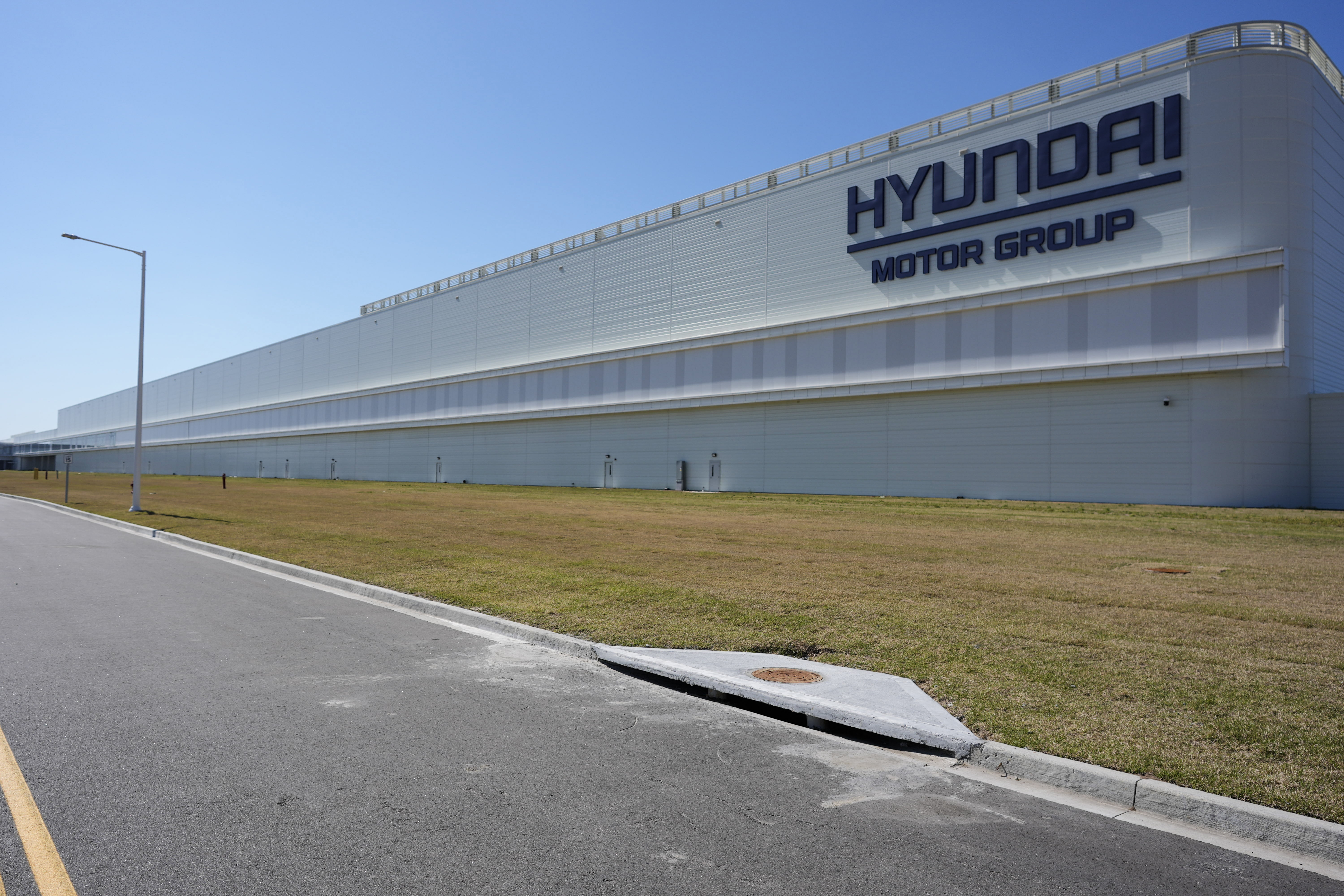 Hyundai Motor Group manufacturing facility with white exterior and blue sky