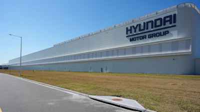 Hyundai Motor Group manufacturing facility with white exterior and blue sky