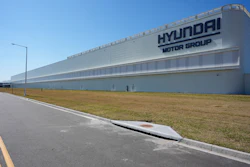 Hyundai Motor Group manufacturing facility with white exterior and blue sky