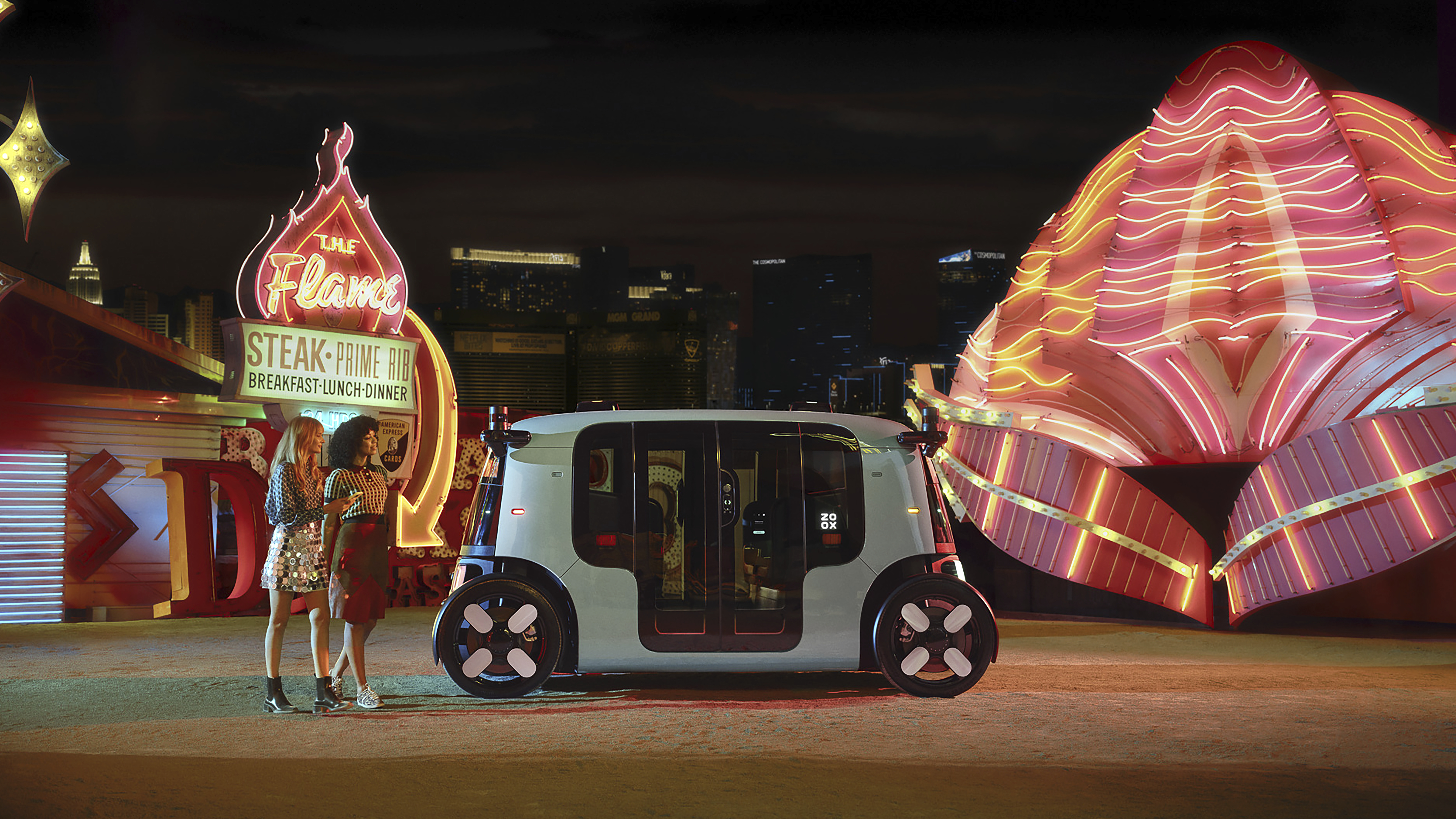 Autonomous white vehicle parked near neon-lit Flame restaurant and glowing architectural structure at night