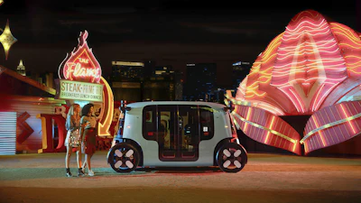 Autonomous white vehicle parked near neon-lit Flame restaurant and glowing architectural structure at night