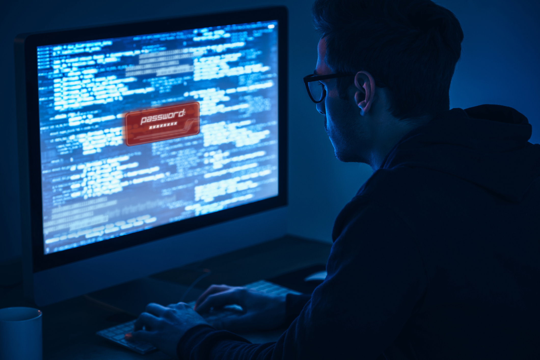 Computer screen showing programming code and password login in dark blue environment