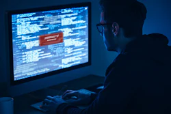 Computer screen showing programming code and password login in dark blue environment