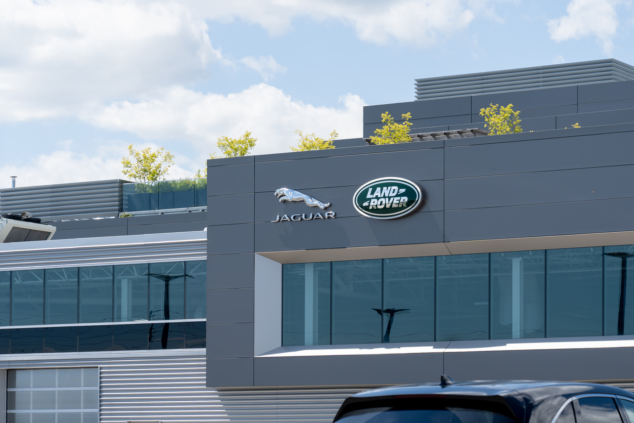 Jaguar Land Rover corporate headquarters with brand logos on modern gray building