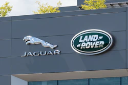 Jaguar Land Rover corporate headquarters with brand logos on modern gray building