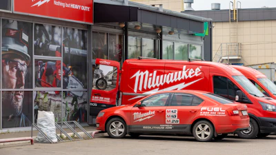 Milwaukee Tools storefront with red branded van and car parked outside industrial building
