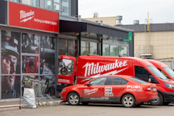 Milwaukee Tools storefront with red branded van and car parked outside industrial building