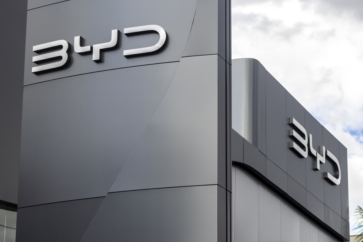 BYD corporate logo mounted on modern gray building exterior