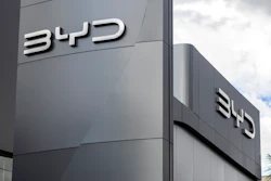 BYD corporate logo mounted on modern gray building exterior