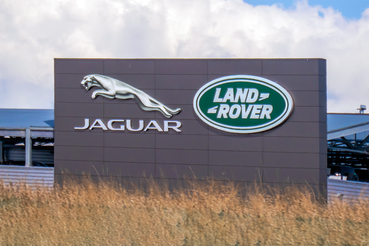 Jaguar Land Rover corporate sign with silver jaguar logo and green Land Rover emblem
