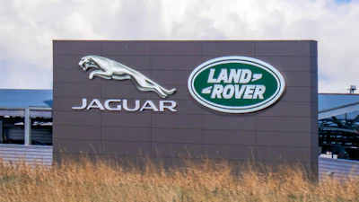 Jaguar Land Rover corporate sign with silver jaguar logo and green Land Rover emblem