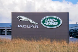 Jaguar Land Rover corporate sign with silver jaguar logo and green Land Rover emblem