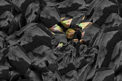 Dark rocky landscape with scattered iridescent crystal formations emerging from black stone formations