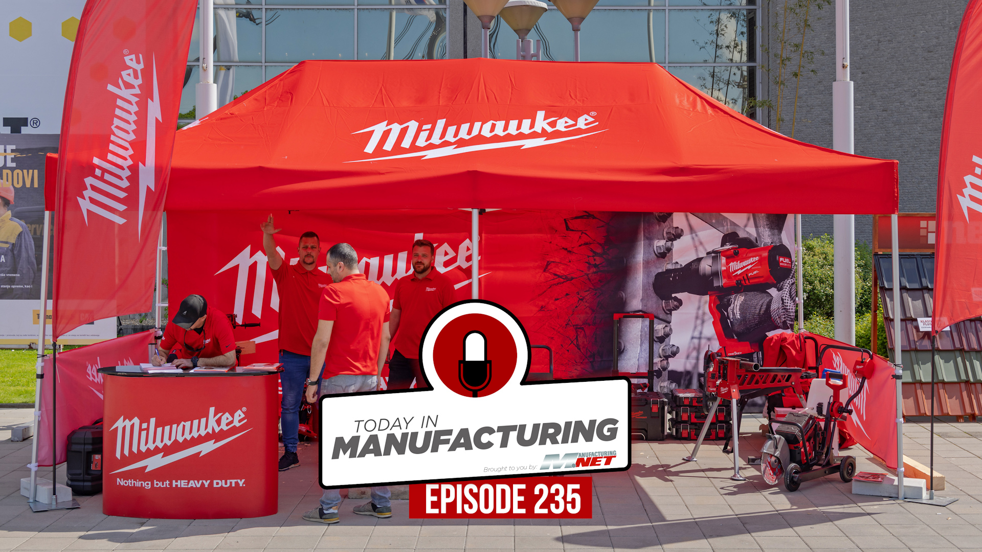 Milwaukee Tools trade show booth with red tent, product displays, and manufacturing equipment