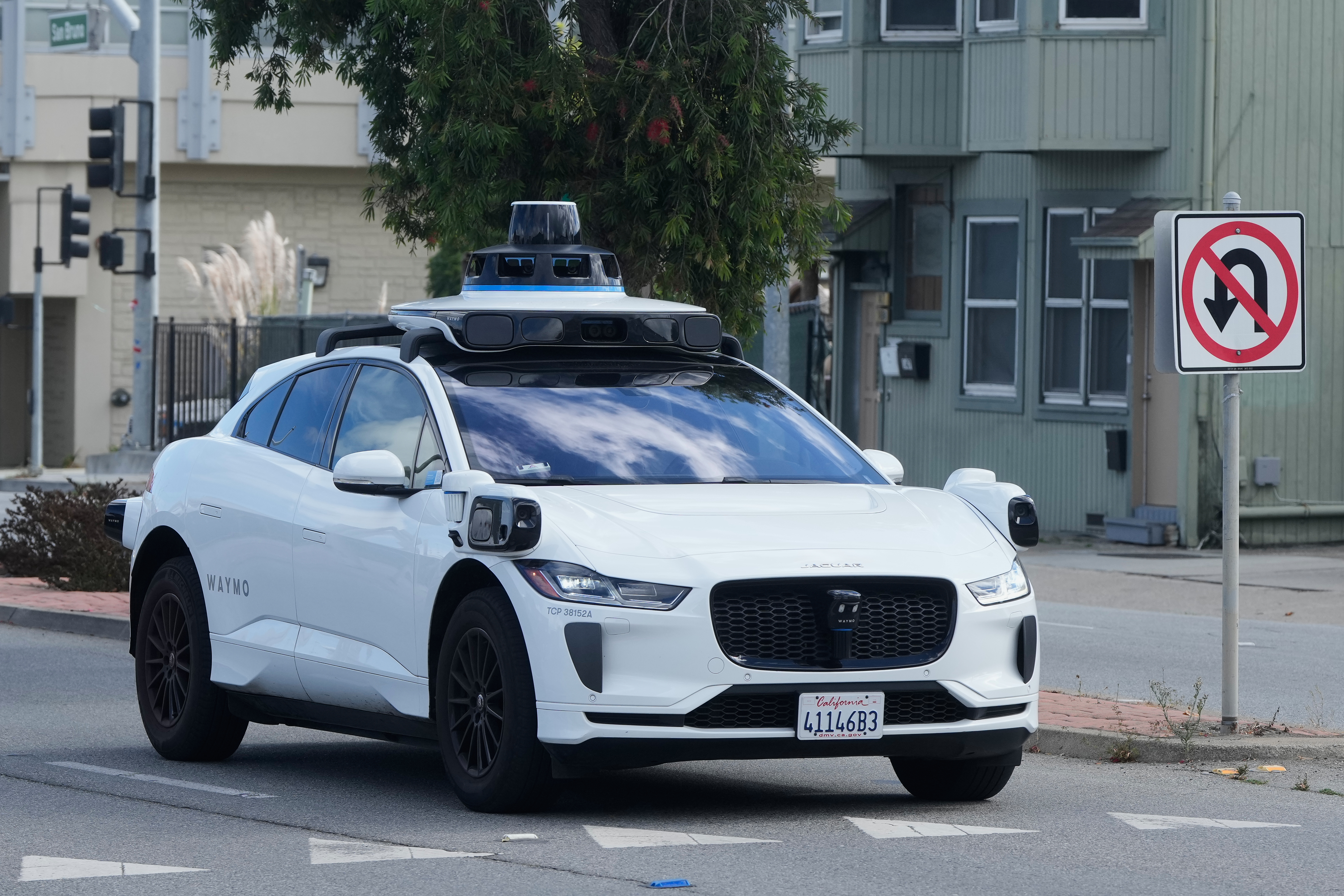 A Waymo vehicle drives past a No U-Turn sign in San Bruno, Calif., Tuesday, Sept. 30, 2025.