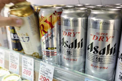 Silver Asahi Super Dry beer cans displayed on store shelf with price tags