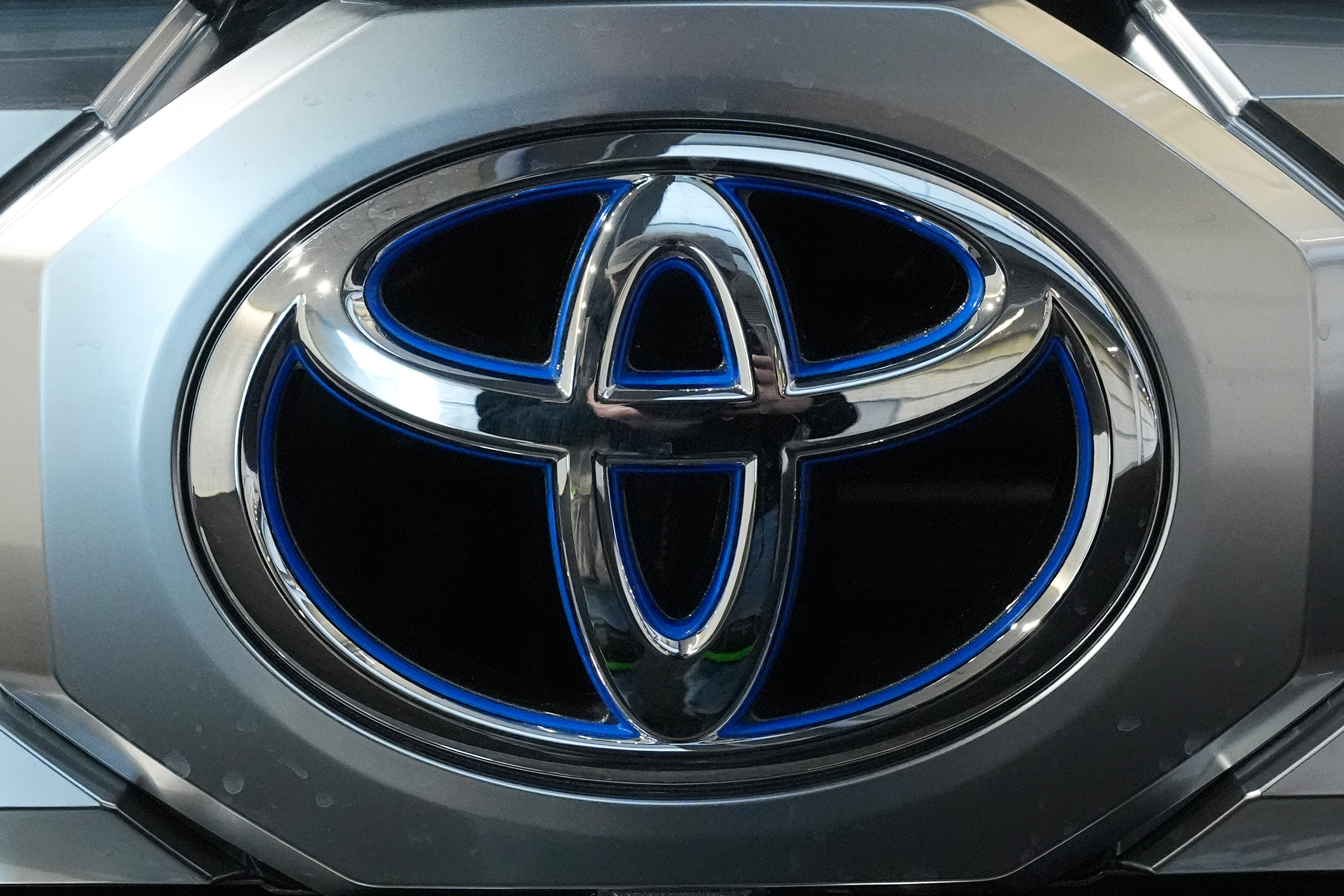 Toyota metallic blue and silver corporate logo emblem
