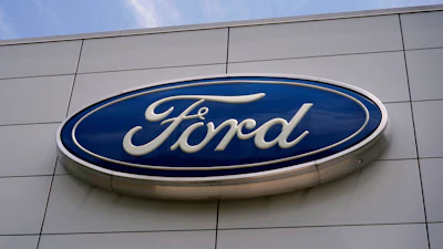 Ford automotive logo in blue and white on modern building exterior