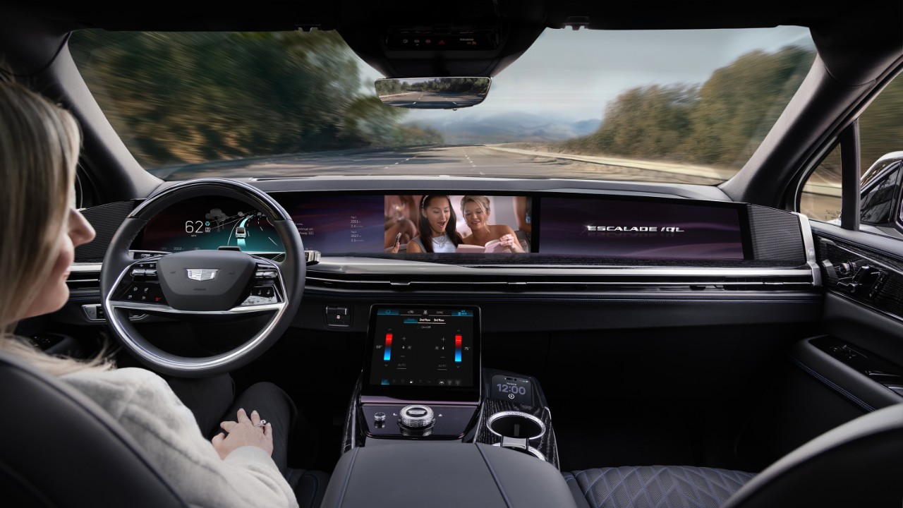 Cadillac Escalade interior dashboard while driving on scenic mountain road