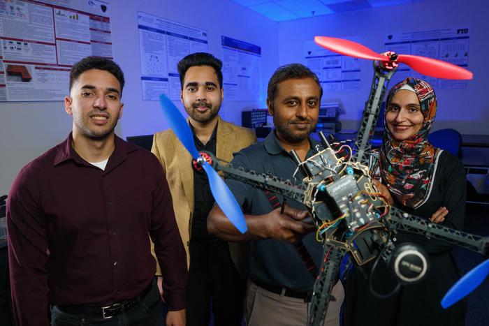 Research team with drone prototype in technical laboratory setting