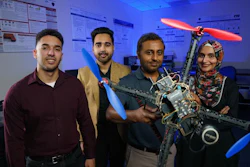 Research team with drone prototype in technical laboratory setting