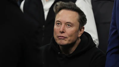 Person wearing black SpaceX hoodie looking off-camera
