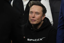 Person wearing black SpaceX hoodie looking off-camera