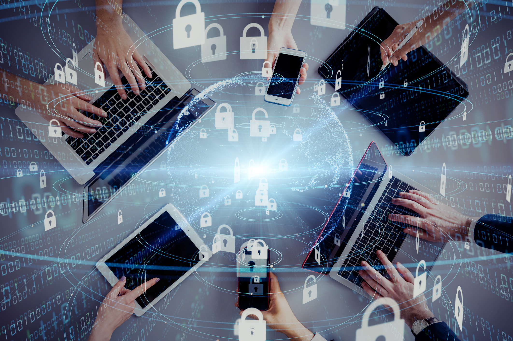 Digital cybersecurity network with hands using laptops and smartphones