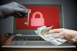 Cybersecurity ransomware concept with key, cash, and locked laptop screen