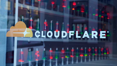 Cloudflare logo on glass window with data center reflection