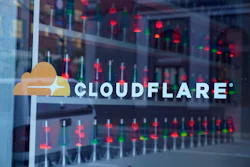 Cloudflare logo on glass window with data center reflection
