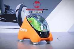 Futuristic orange Toyota concept vehicle with transparent green bubble canopy