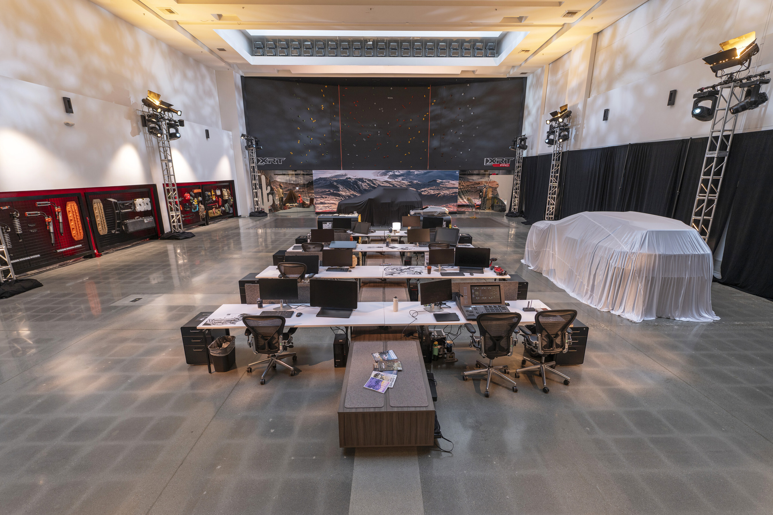 Large studio workspace with workstations, computers, and technical staging equipment