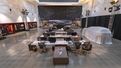 Large studio workspace with workstations, computers, and technical staging equipment