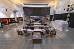 Large studio workspace with workstations, computers, and technical staging equipment