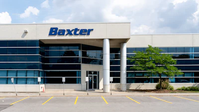 Baxter corporate headquarters building with blue glass exterior and white columns