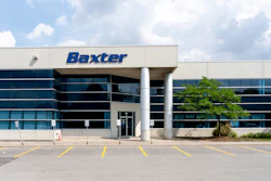 Baxter corporate headquarters building with blue glass exterior and white columns