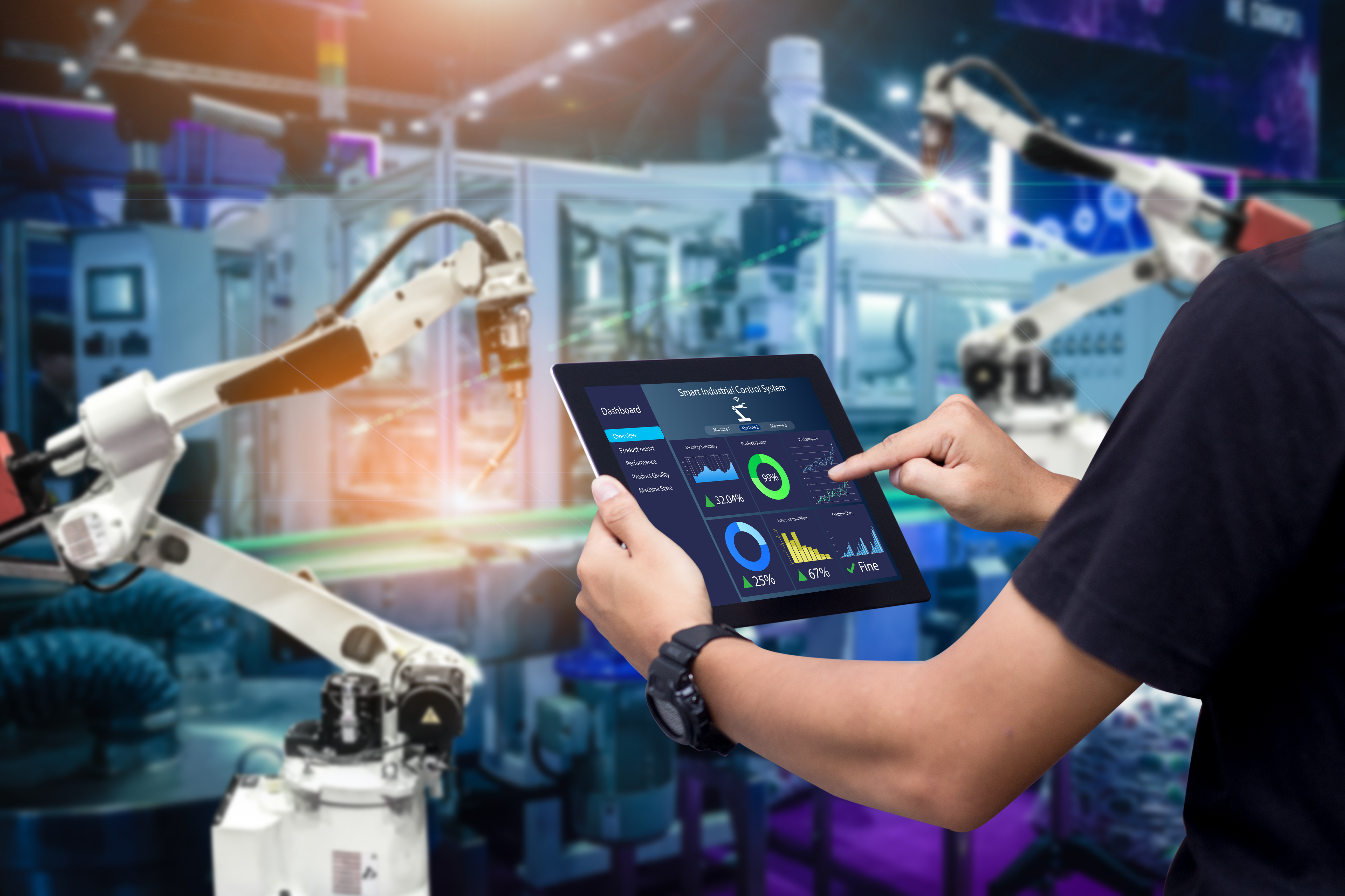 Industrial technician monitoring robotic systems using digital tablet with performance analytics