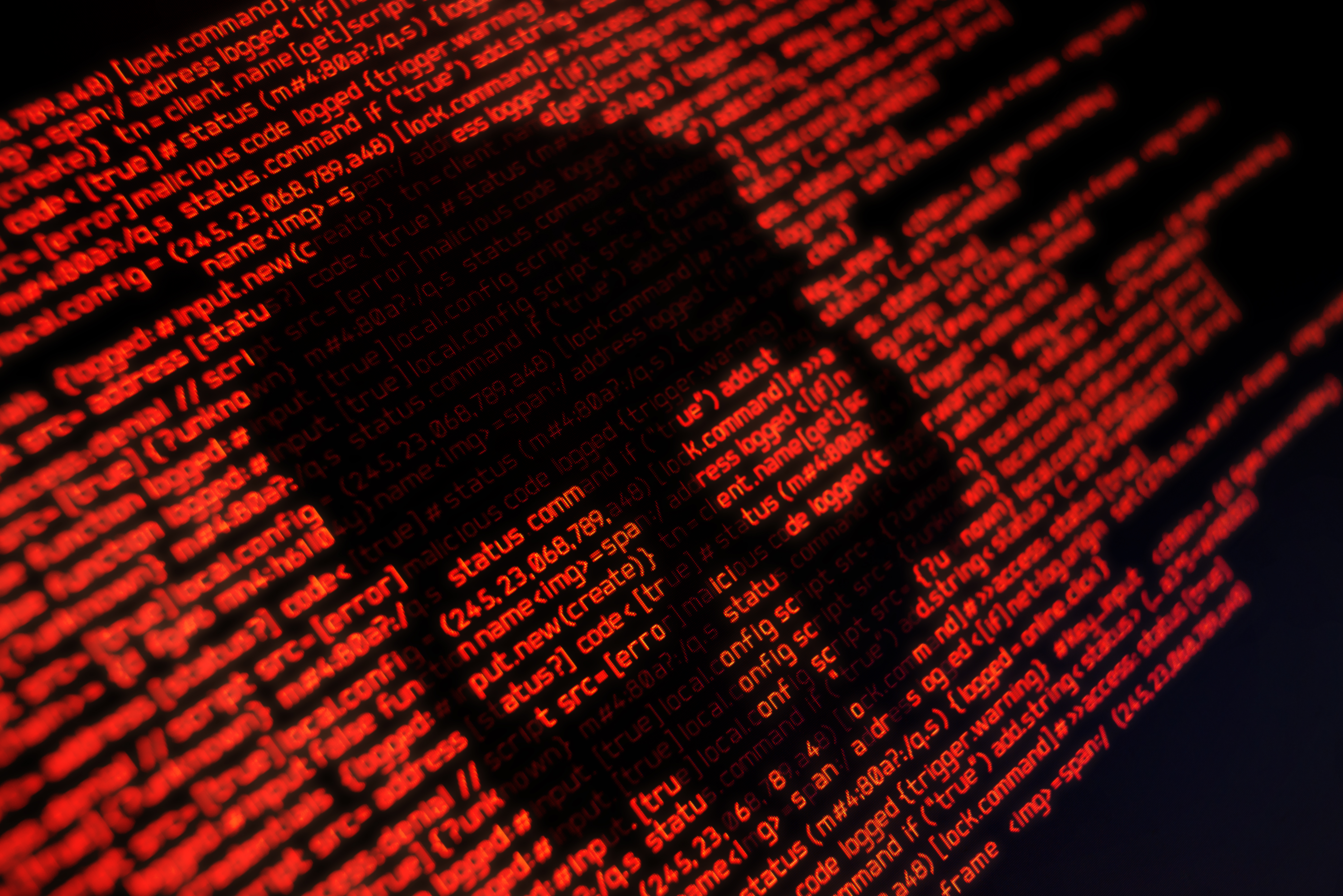Digital red code forming skull shape, representing cybersecurity threat